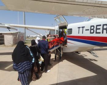 Aziza being removed from the plane