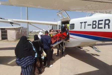 Aziza being removed from the plane
