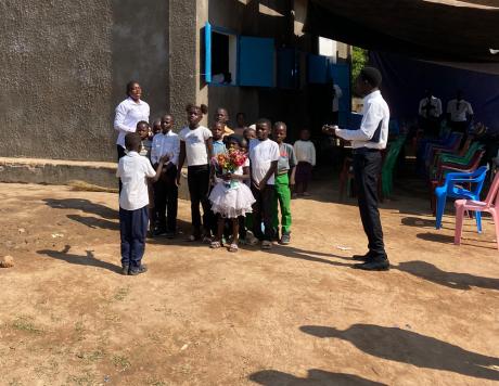 A children's choir welcomes the visitors